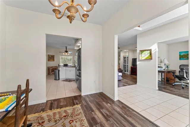 a bedroom with wooden floor and a chandelier