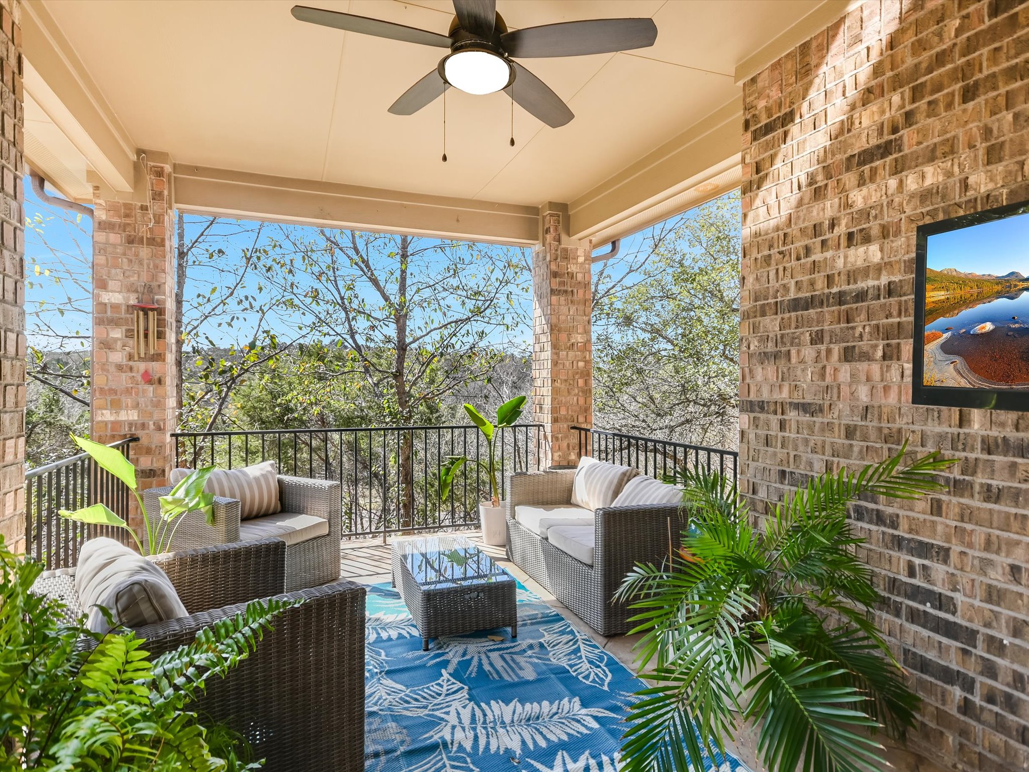 201 Bellagio Drive Austin, TX 78734 - Photo 2 of 31 Out back, a showstopper entertainer’s covered porch overlooks a wooded greenbelt with no rear neighbors, offering privacy and a peaceful backdrop.