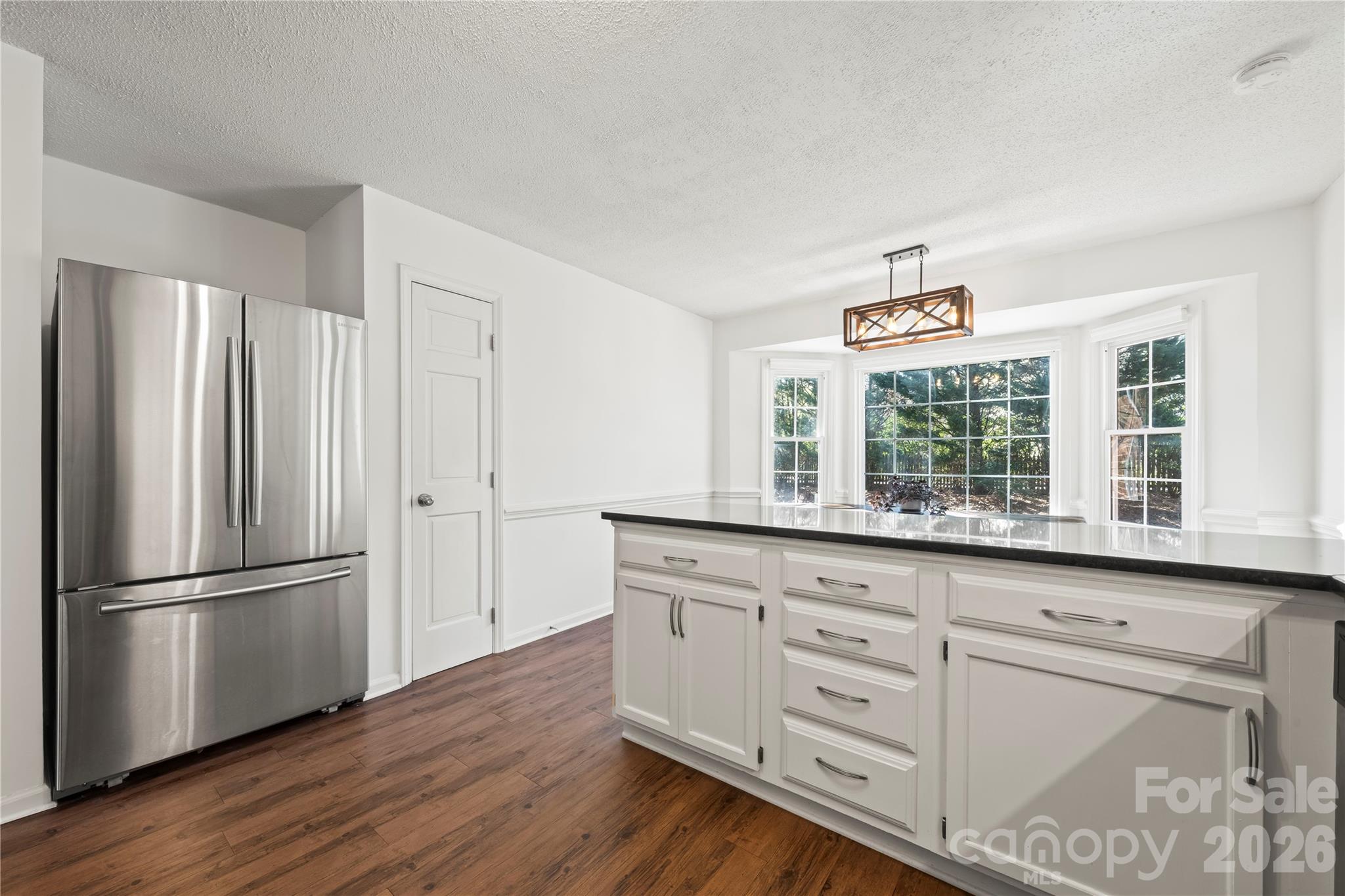 6101 Boykin Spaniel Road Charlotte, NC 28277 - Photo 14 of 40 a kitchen with granite countertop white cabinets and wooden floor
