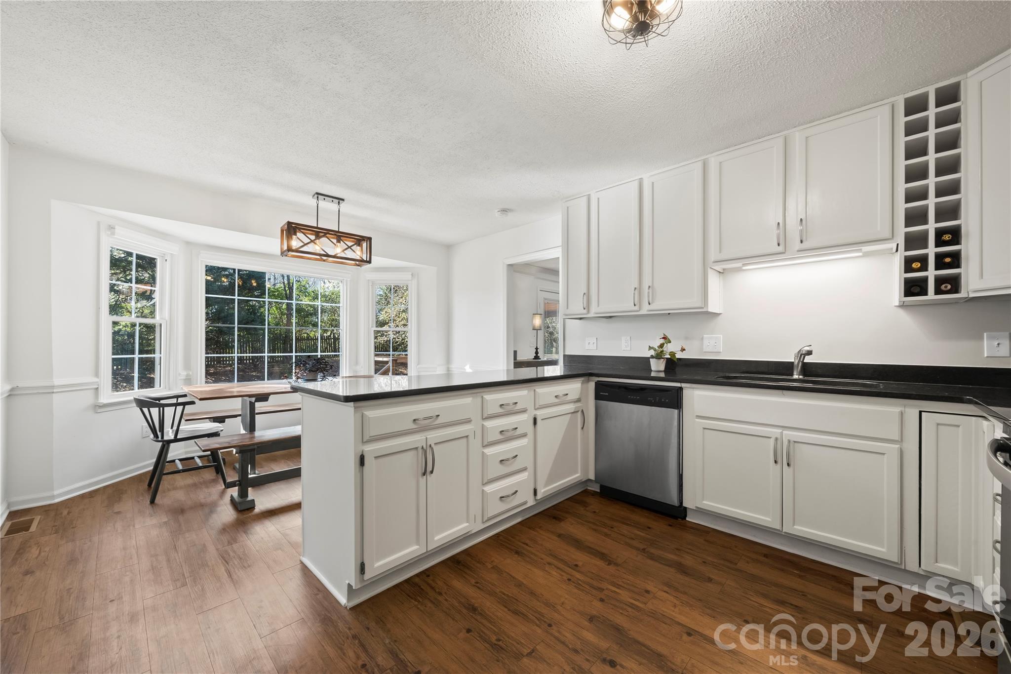 6101 Boykin Spaniel Road Charlotte, NC 28277 - Photo 15 of 40 a kitchen with granite countertop white cabinets and wooden floor