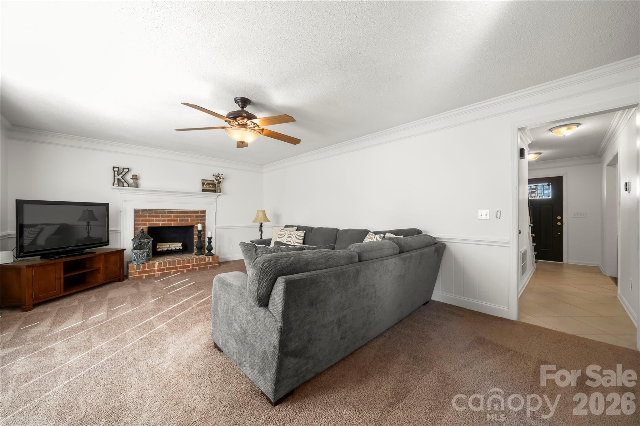 6101 Boykin Spaniel Road Charlotte, NC 28277 - Photo 18 of 40 a living room with furniture a fireplace and a flat screen tv