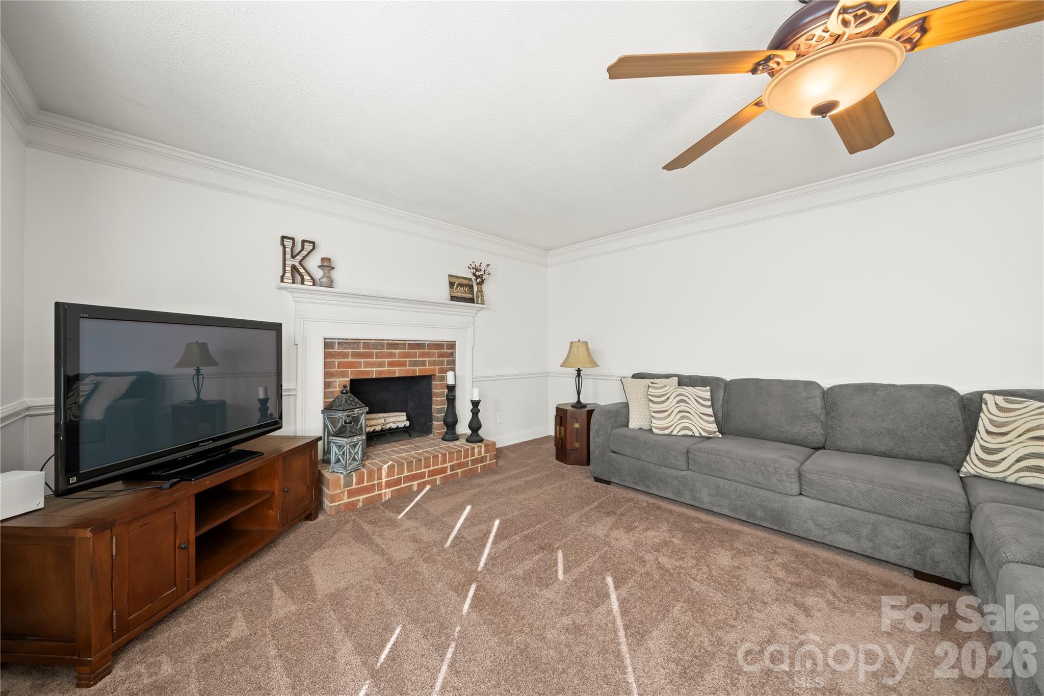 6101 Boykin Spaniel Road Charlotte, NC 28277 - Photo 20 of 40 a living room with furniture a flat screen tv and a fireplace