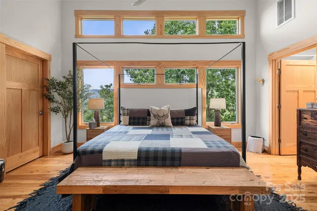 a bedroom with a bed and wooden floor