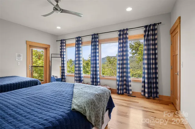 a spacious bedroom with a large bed and a large window