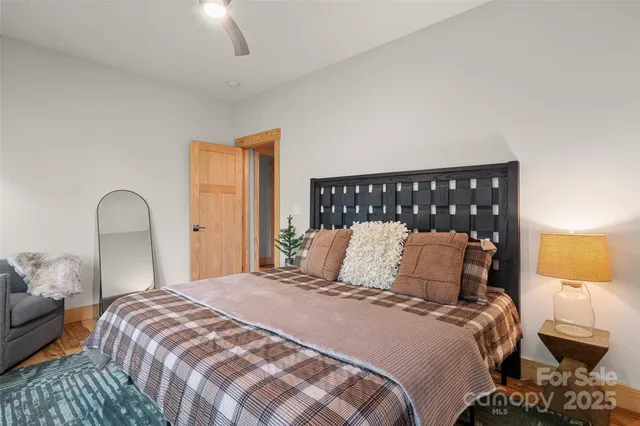 a bedroom with a bed and wooden floor