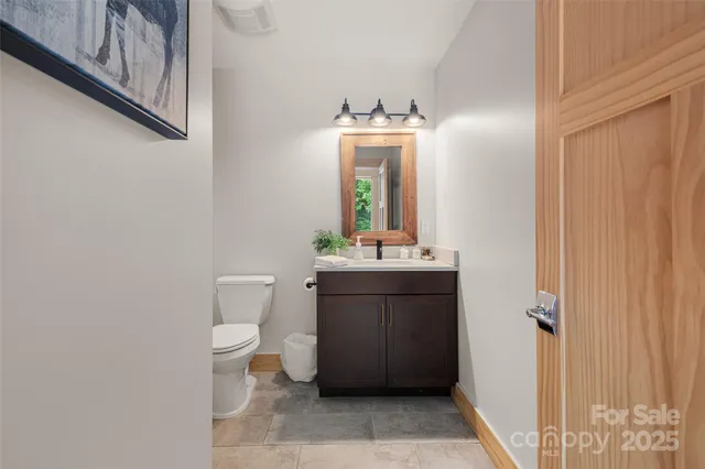 a view of a hallway with wooden floor and stairs