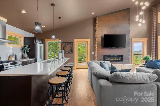 a living room with furniture a flat screen tv and a fireplace