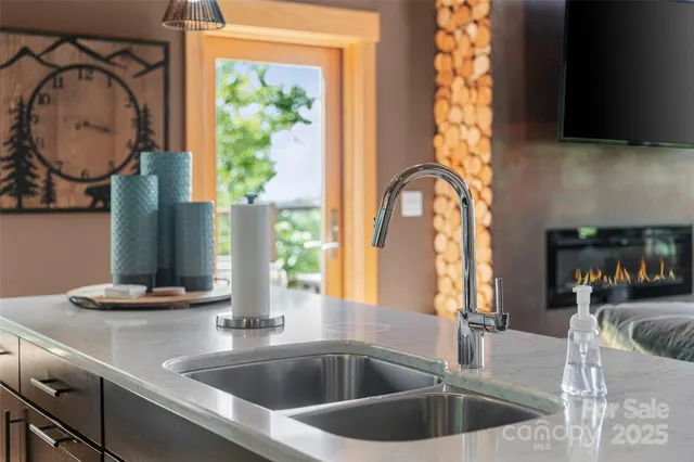 a kitchen with a sink and a large mirror