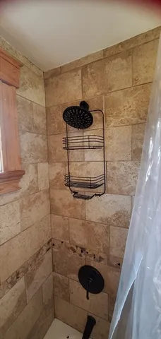 a bathroom with a sink and mirror with toilet