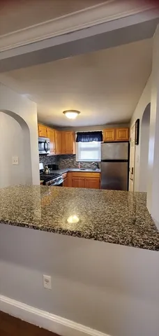a view of kitchen cabinets and wooden floor