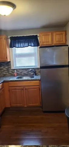 a kitchen with granite countertop a stove and a sink