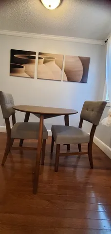 a view of dining room and kitchen with furniture and wooden floor