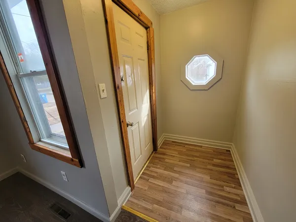 a view of a room with wooden floor and glass door