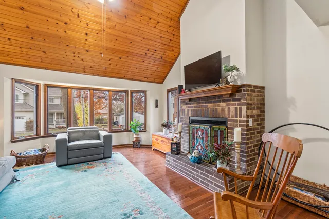 a living room with furniture fireplace and flat screen tv