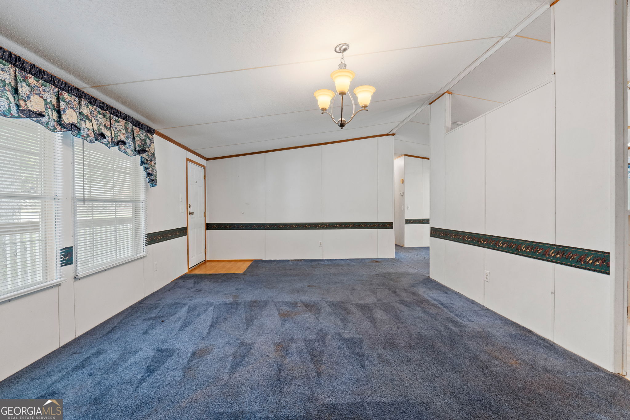 868 South Steel Bridge Road Eatonton, GA 31024 - Photo 26 of 64 a view of an empty room with wooden floor