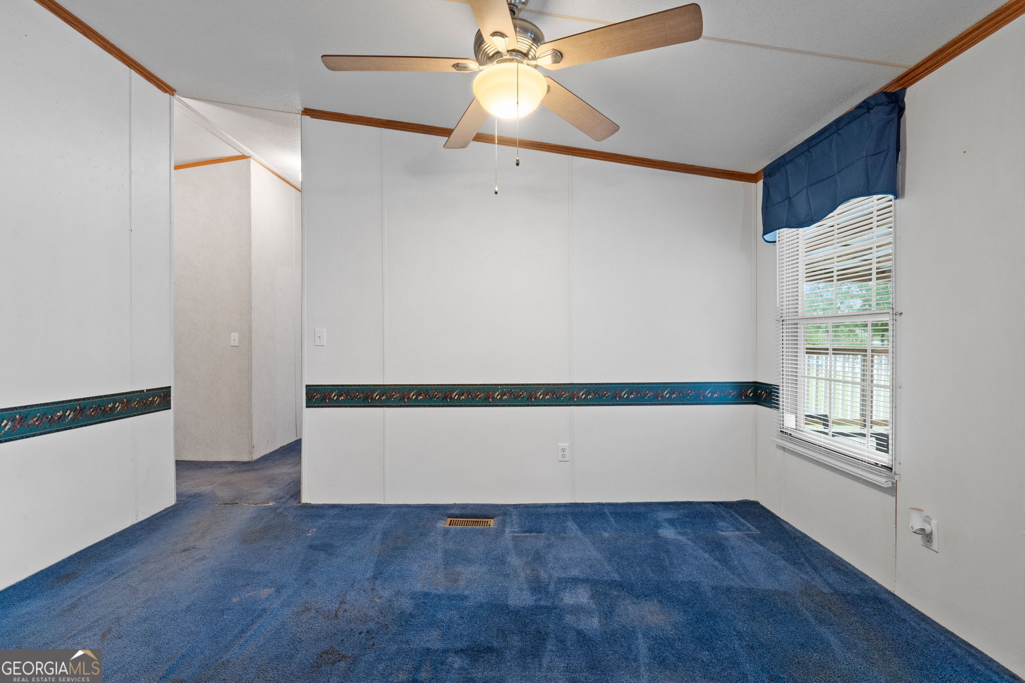 868 South Steel Bridge Road Eatonton, GA 31024 - Photo 29 of 64 a view of an empty room with a window and wooden floor