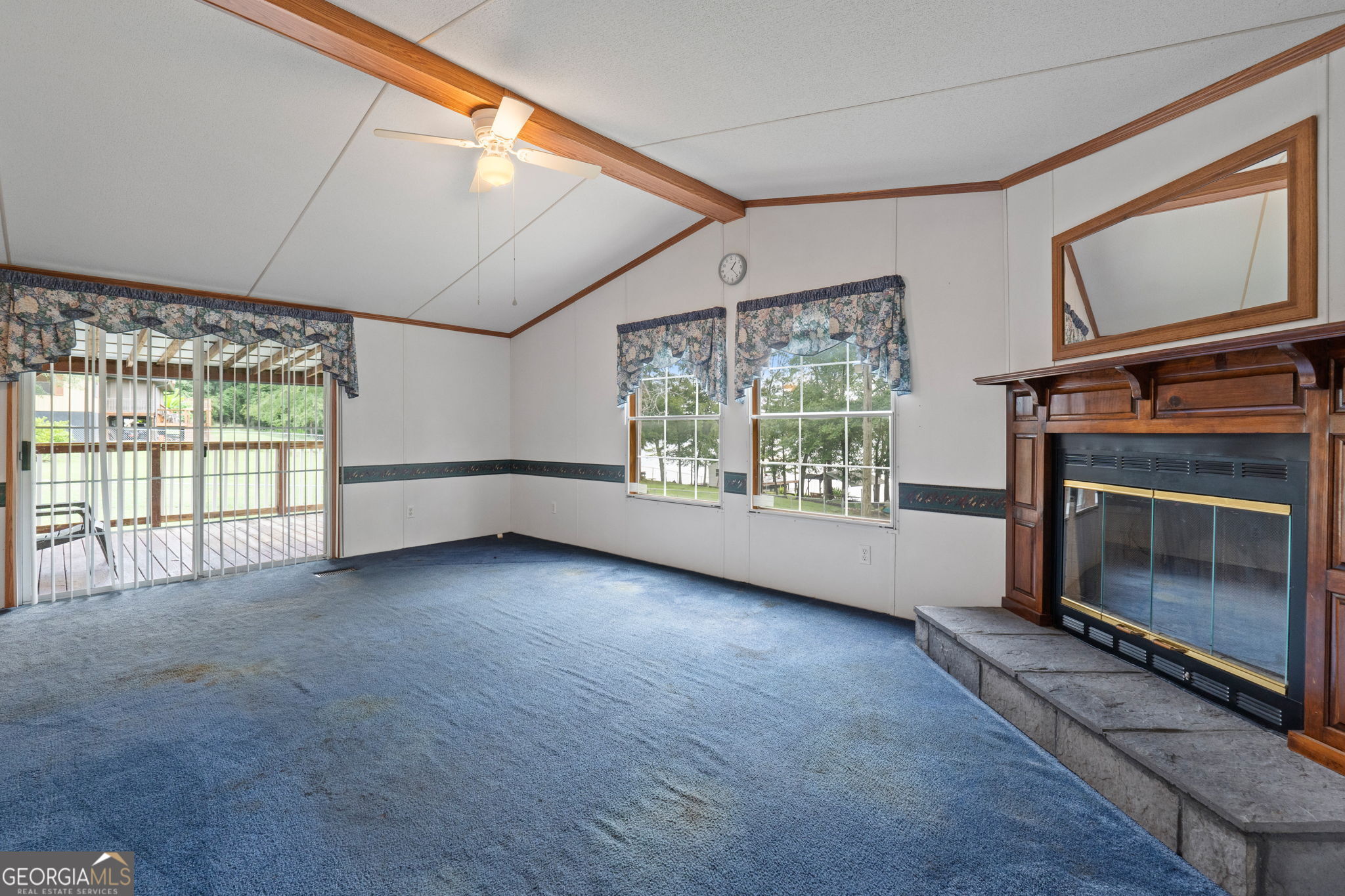 868 South Steel Bridge Road Eatonton, GA 31024 - Photo 34 of 64 a view of an empty room with a fireplace and a window