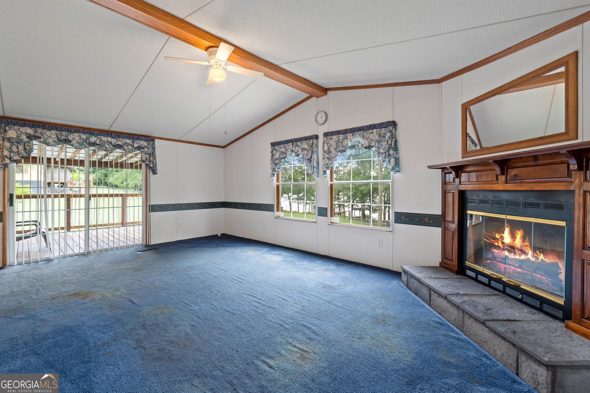 868 South Steel Bridge Road Eatonton, GA 31024 - Photo 35 of 64 a view of an empty room with a fireplace and a window