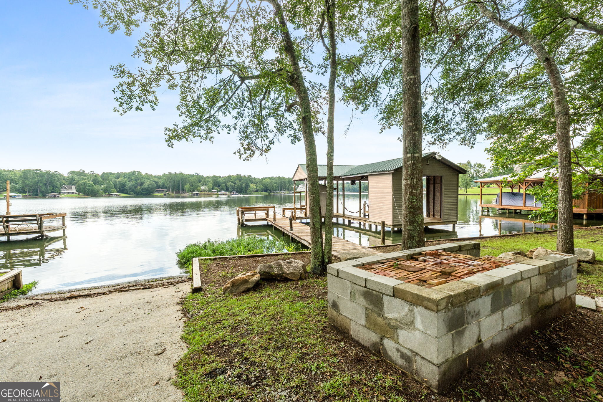 868 South Steel Bridge Road Eatonton, GA 31024 - Photo 4 of 64 a view of a house with lake and trees in the background