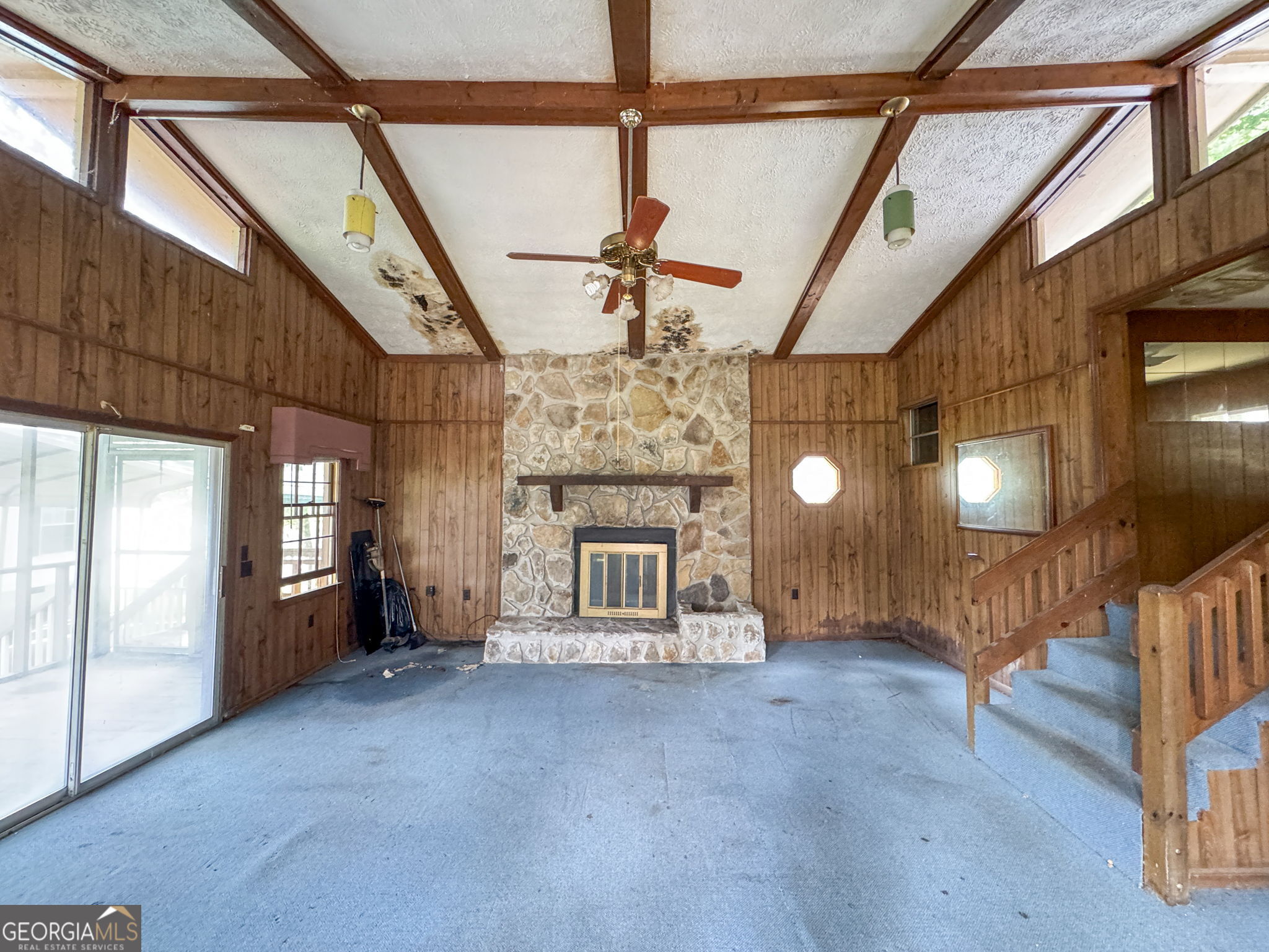 868 South Steel Bridge Road Eatonton, GA 31024 - Photo 55 of 64 a view of a hallway with a fireplace and chandelier