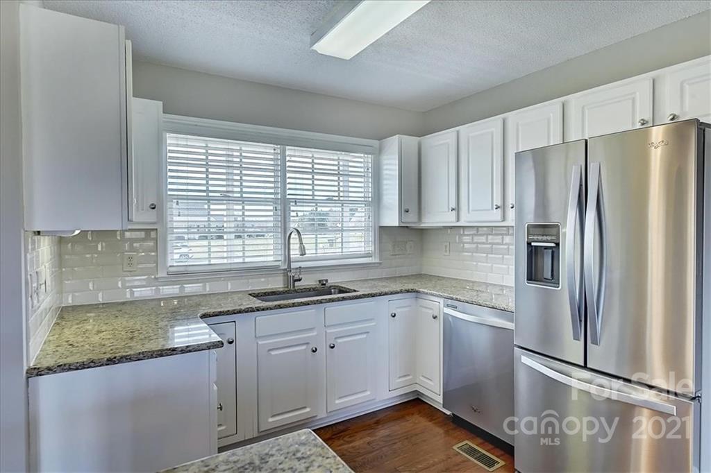 4103 Watson Church Road Monroe, NC 28110 - Photo 3 of 28 a kitchen with a sink stove and refrigerator