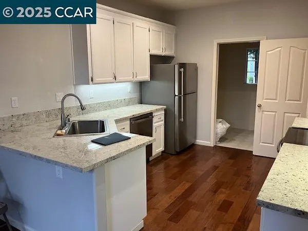 a kitchen with a sink a refrigerator and a stove
