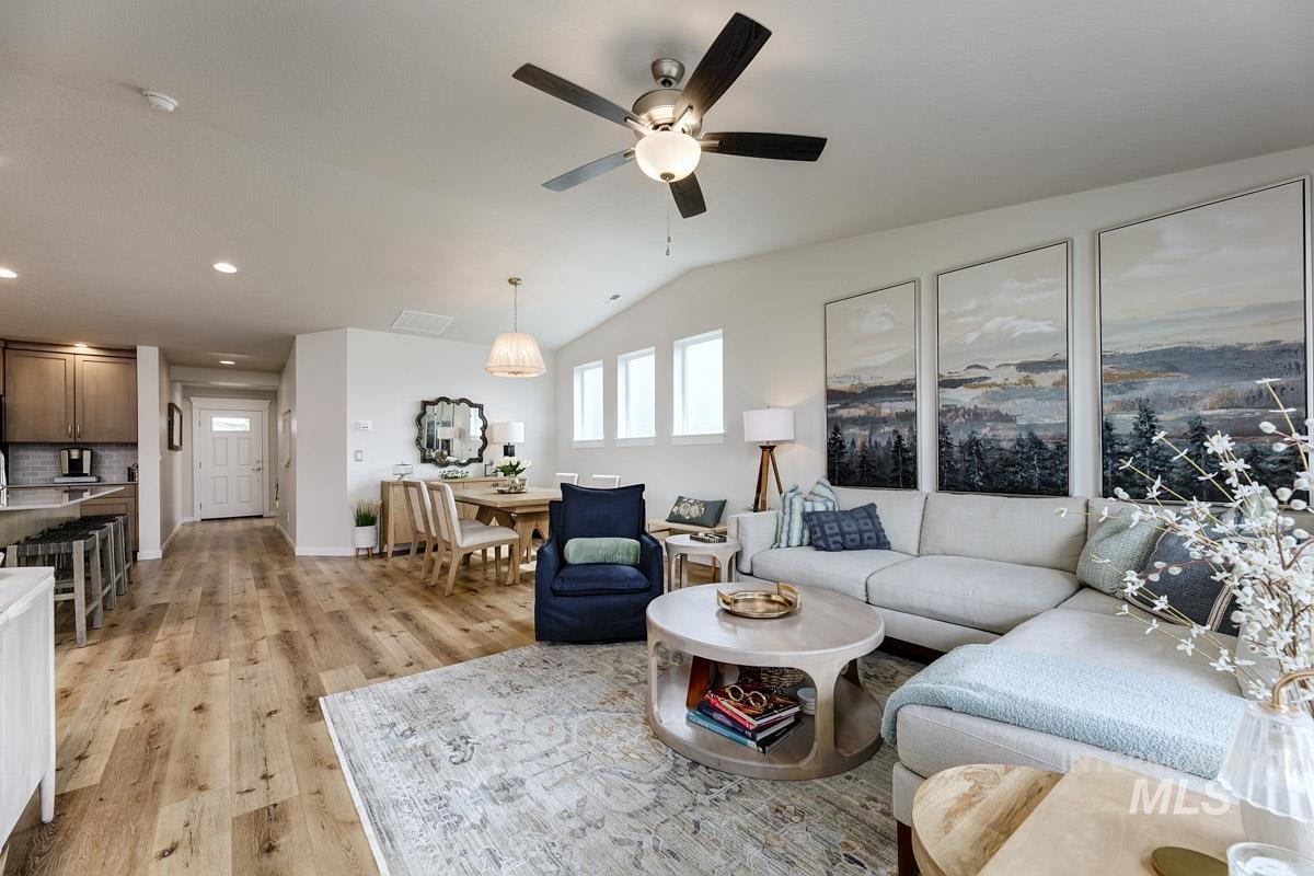 348 West Radiant Rdg Drive Meridian, ID 83642 - Photo 14 of 36 Vaulted ceiling with an attached ceiling fan, wood-finish flooring, recessed lighting, and multiple windows providing ambient illumination
