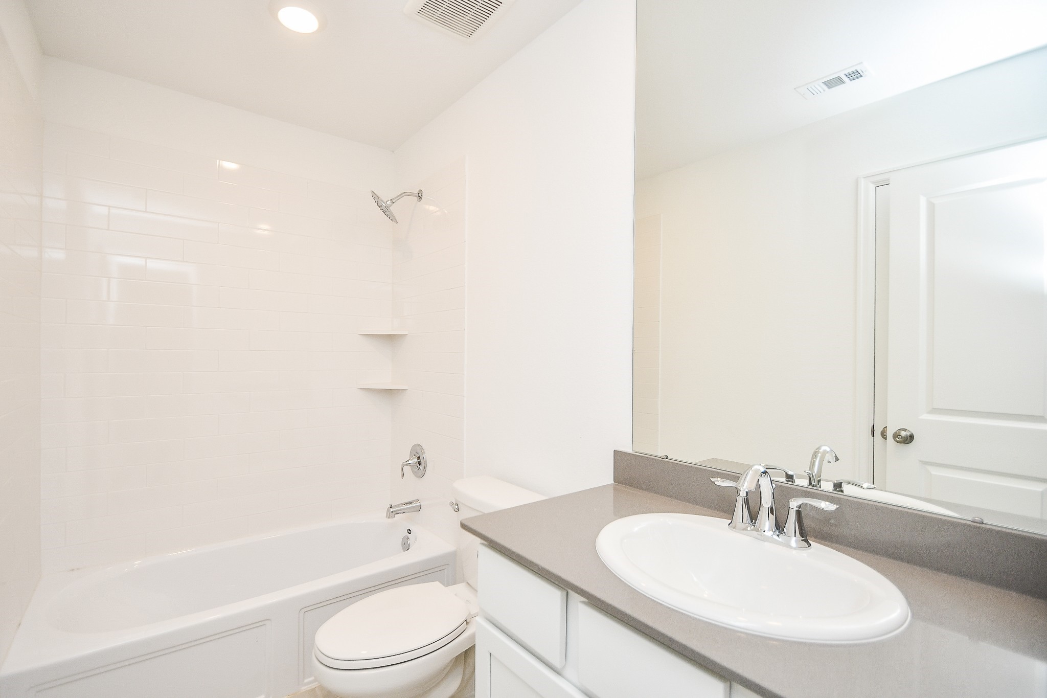 5624 Frst Cv Drive Rosenberg, TX 77469 - Photo 12 of 32 a bathroom with a bathtub shower sink vanity mirror and toilet