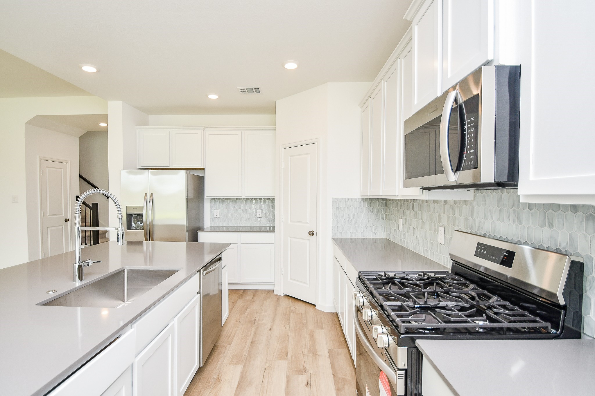 5624 Frst Cv Drive Rosenberg, TX 77469 - Photo 25 of 32 a kitchen with stainless steel appliances granite countertop a sink stove and refrigerator