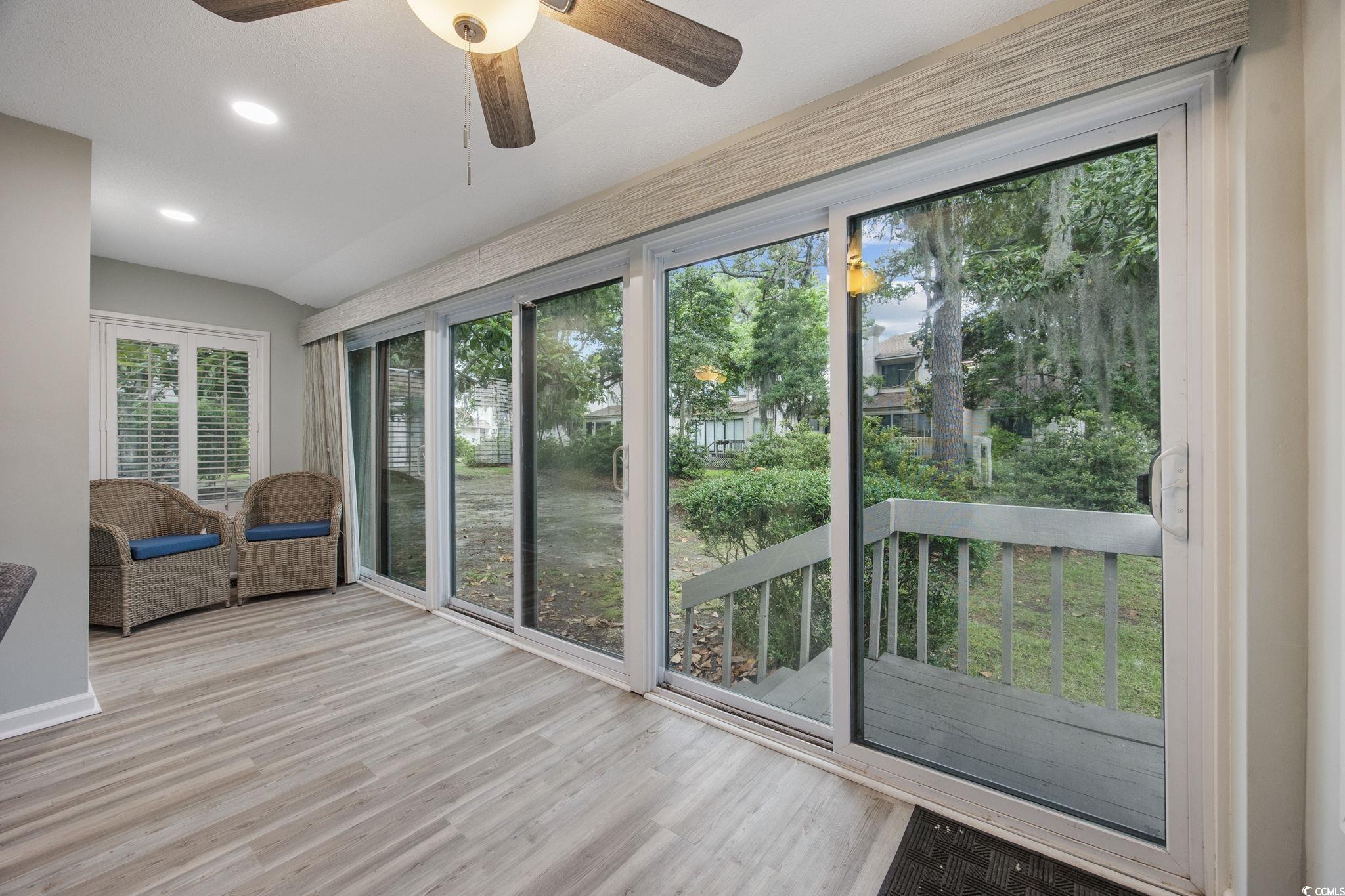 64 Bamboo Loop, Unit 161 Georgetown, SC 29440 - Photo 20 of 31 Unfurnished sunroom featuring ceiling fan, wood finished floors, recessed lighting, a deck, and lofted ceiling