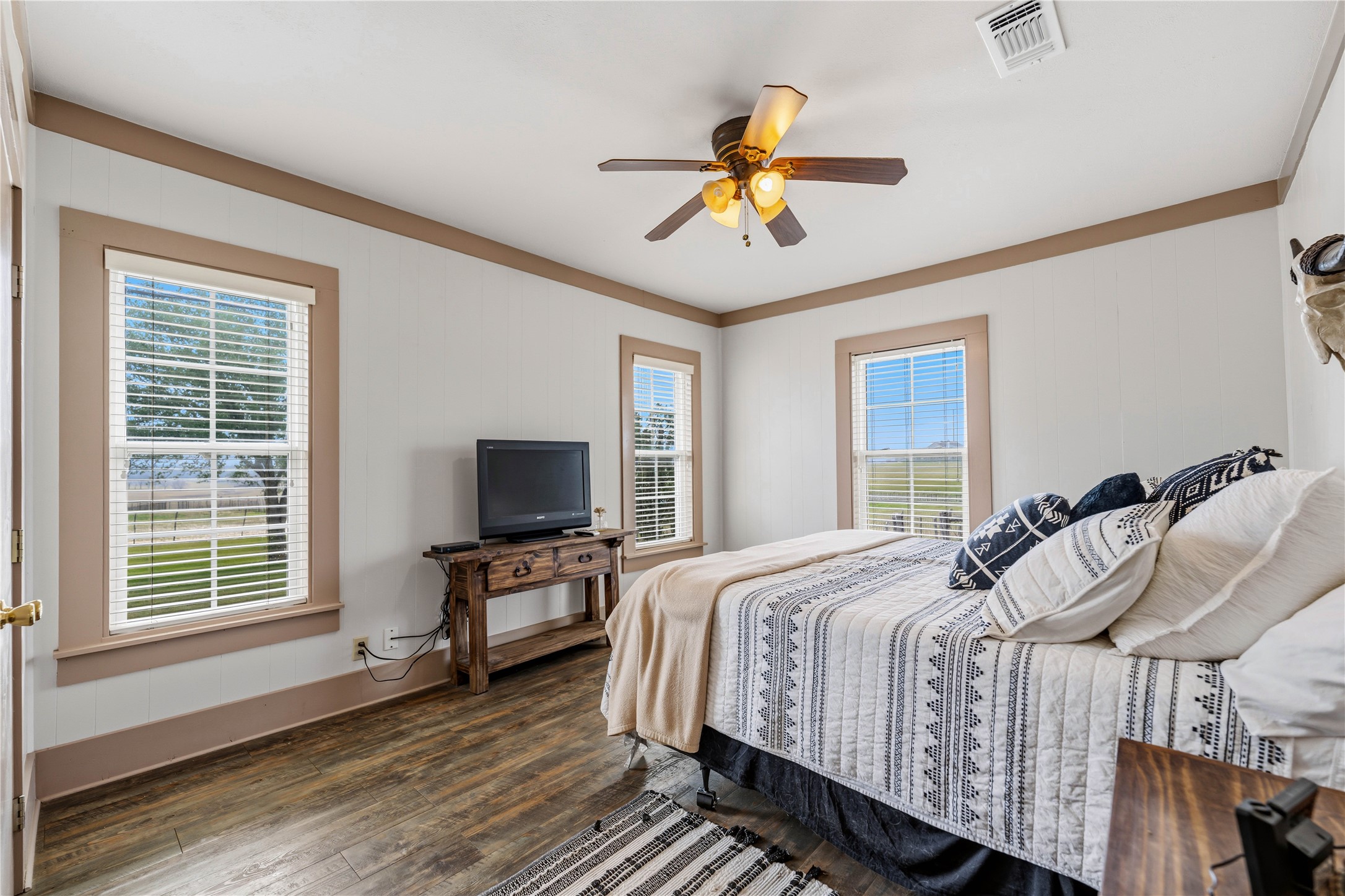 1119 Wolters Road Schulenburg, TX 78956 - Photo 16 of 39 a bedroom with a bed and wooden floor