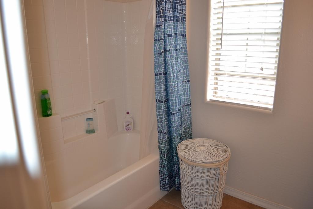 2772 Mason Ridge Road Show Low, AZ 85901 - Photo 19 of 51 a bathroom with a sink a toilet a window and shower