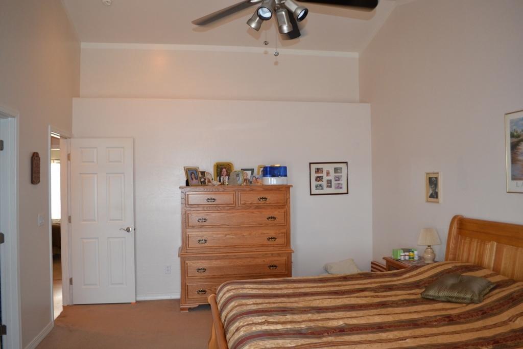2772 Mason Ridge Road Show Low, AZ 85901 - Photo 23 of 51 a bedroom with a bed and a chandelier