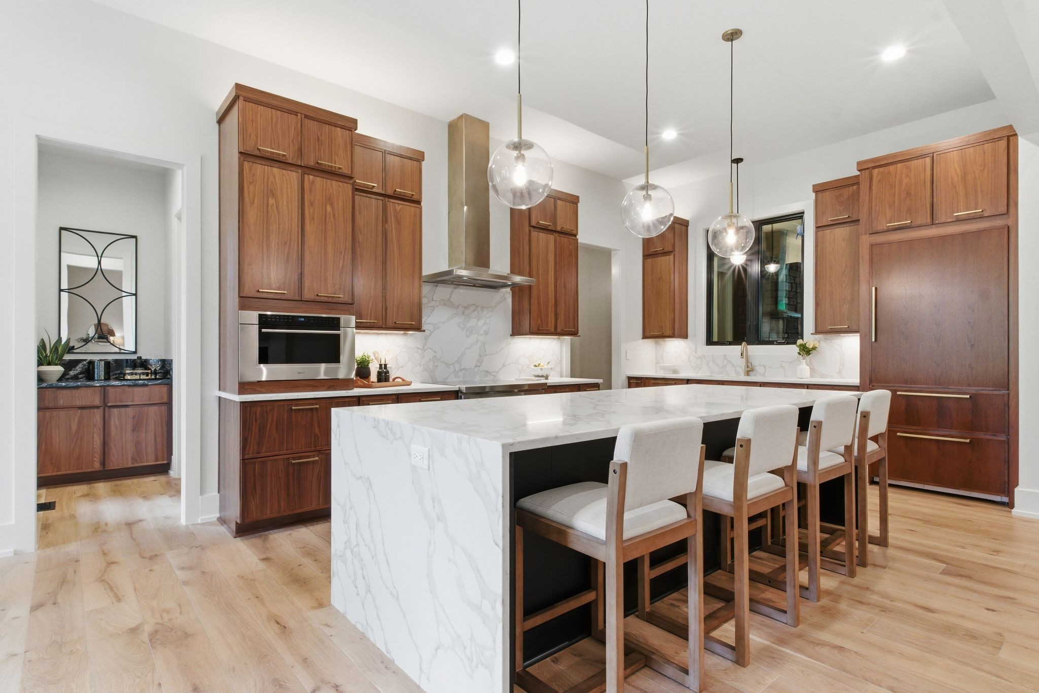 1002 Waller Road Brentwood, TN 37027 - Photo 10 of 54 a kitchen with stainless steel appliances kitchen island granite countertop a table chairs and a refrigerator