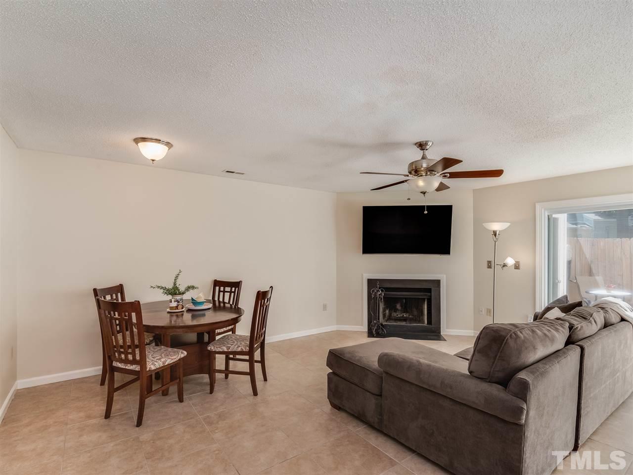 5932 Shady Grove Circle Raleigh, NC 27609 - Photo 11 of 28 a living room with furniture a flat screen tv and a fireplace