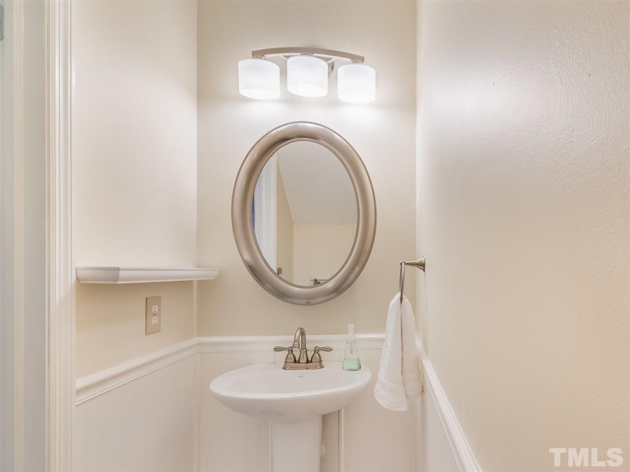 5932 Shady Grove Circle Raleigh, NC 27609 - Photo 18 of 28 a bathroom with a sink and a mirror