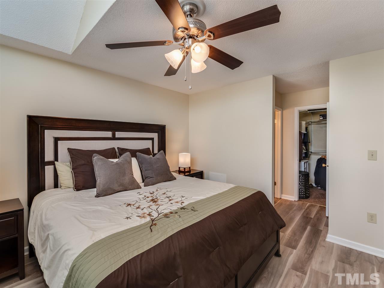 5932 Shady Grove Circle Raleigh, NC 27609 - Photo 20 of 28 a bedroom with a large bed and a chandelier