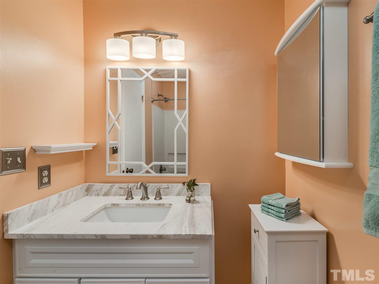 5932 Shady Grove Circle Raleigh, NC 27609 - Photo 21 of 28 a bathroom with a sink and a mirror