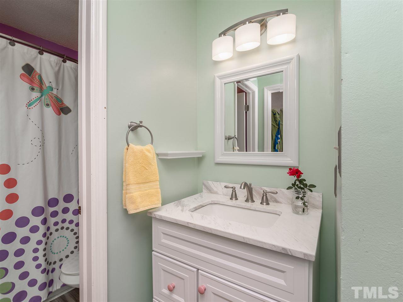 5932 Shady Grove Circle Raleigh, NC 27609 - Photo 24 of 28 a bathroom with a sink and a mirror
