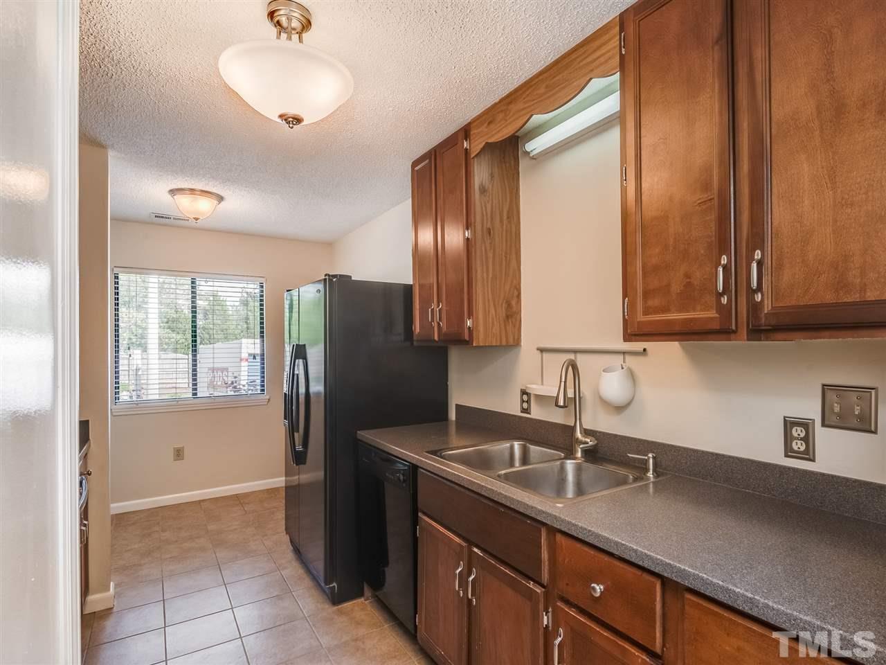 5932 Shady Grove Circle Raleigh, NC 27609 - Photo 5 of 28 a kitchen with stainless steel appliances granite countertop a sink refrigerator and cabinets