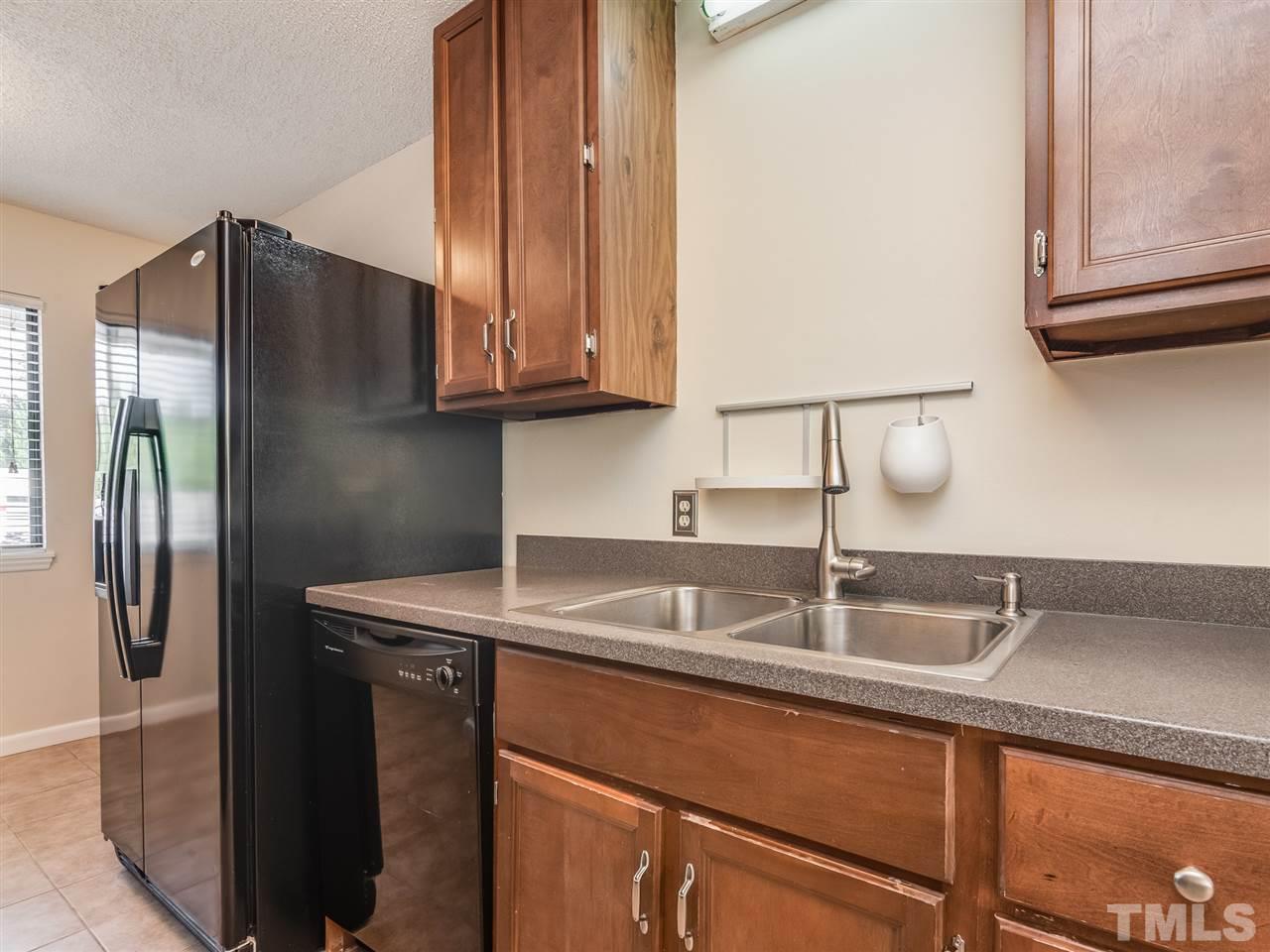 5932 Shady Grove Circle Raleigh, NC 27609 - Photo 6 of 28 a kitchen with stainless steel appliances granite countertop a refrigerator and a sink