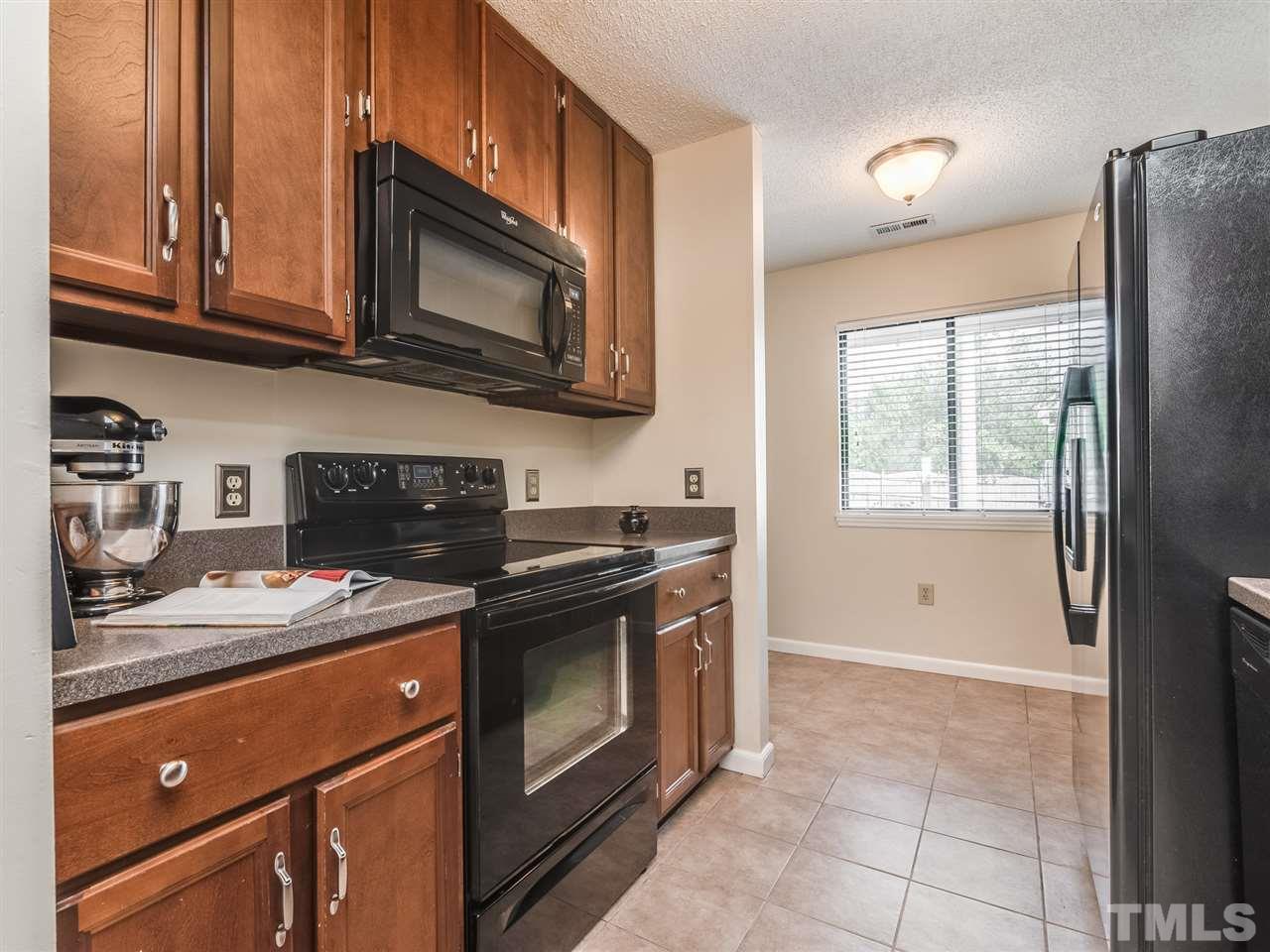 5932 Shady Grove Circle Raleigh, NC 27609 - Photo 7 of 28 a kitchen with stainless steel appliances granite countertop a stove a microwave and a refrigerator