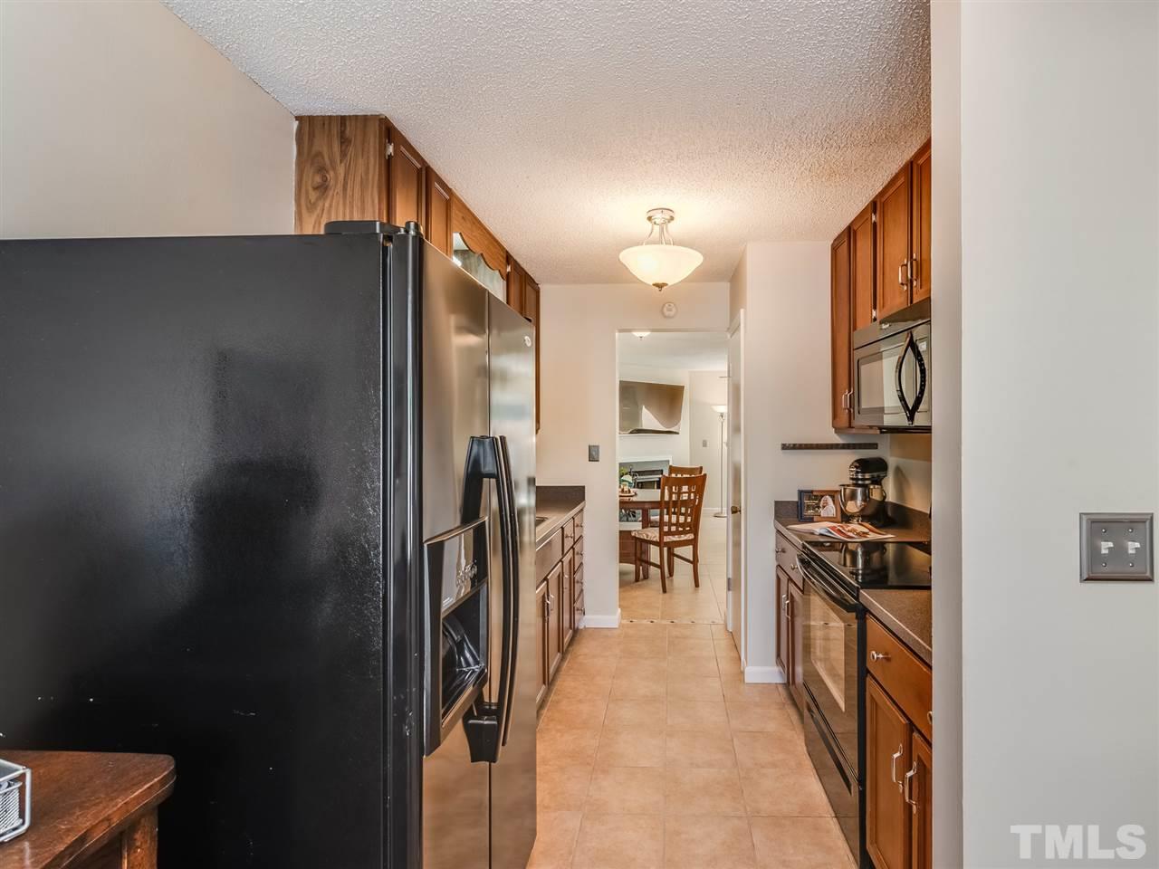 5932 Shady Grove Circle Raleigh, NC 27609 - Photo 8 of 28 a kitchen with a refrigerator and a stove