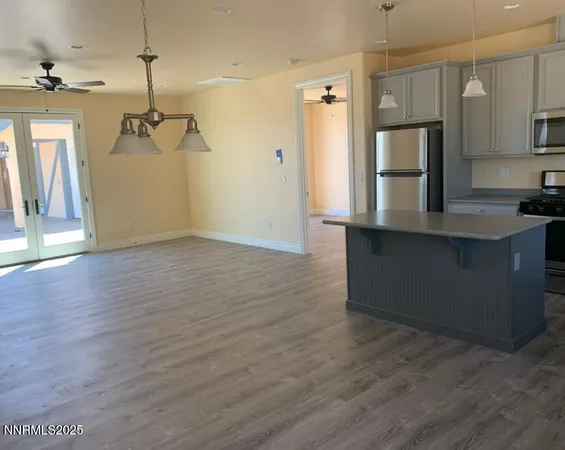 a view of a kitchen with a sink wooden floor and a window