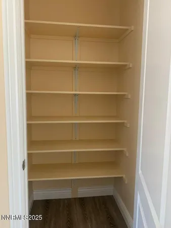 a view of walk in closet with empty racks