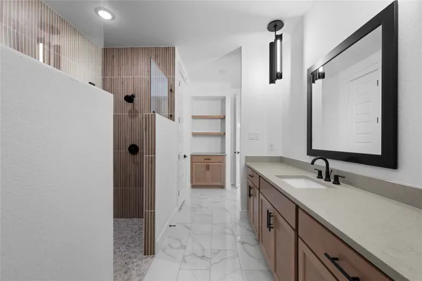 a bathroom with a tub sink and mirror