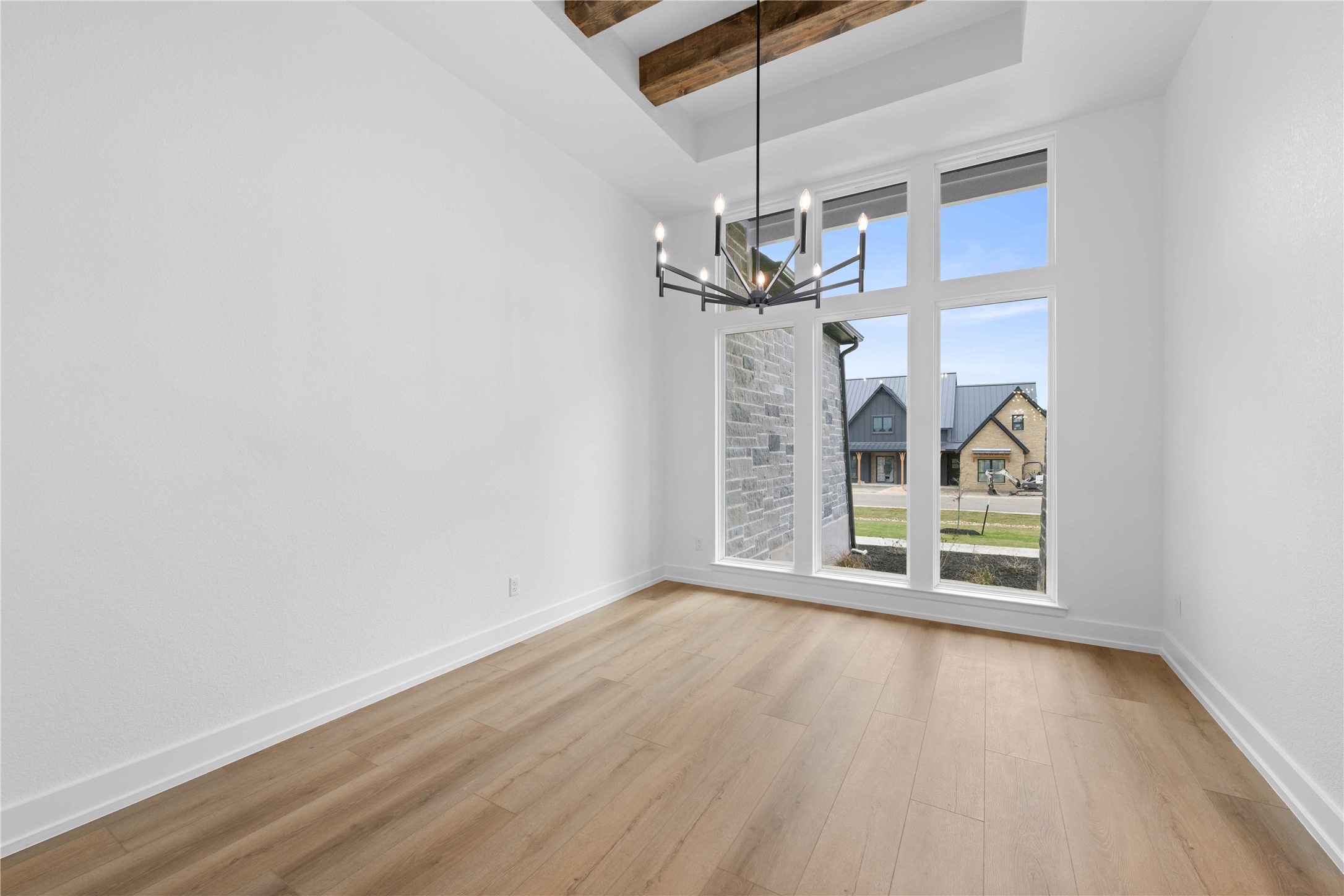 520 Vale Pond Spur Georgetown, TX 78633 - Photo 21 of 32 an empty room with wooden floor chandelier and entryway