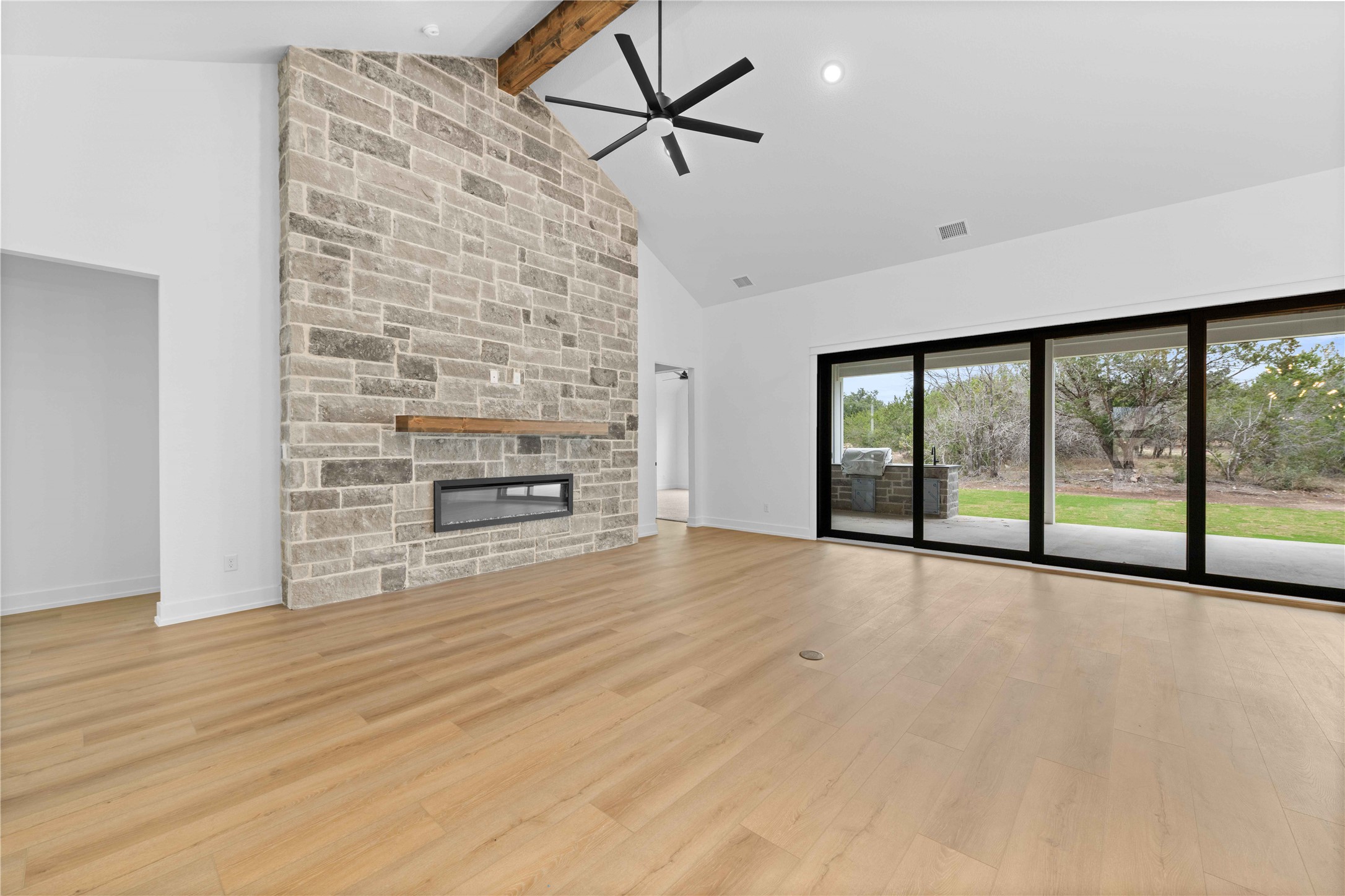 520 Vale Pond Spur Georgetown, TX 78633 - Photo 26 of 32 wooden floor fireplace and windows in an empty room