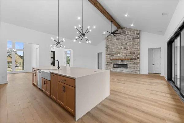 an empty room with windows and fireplace