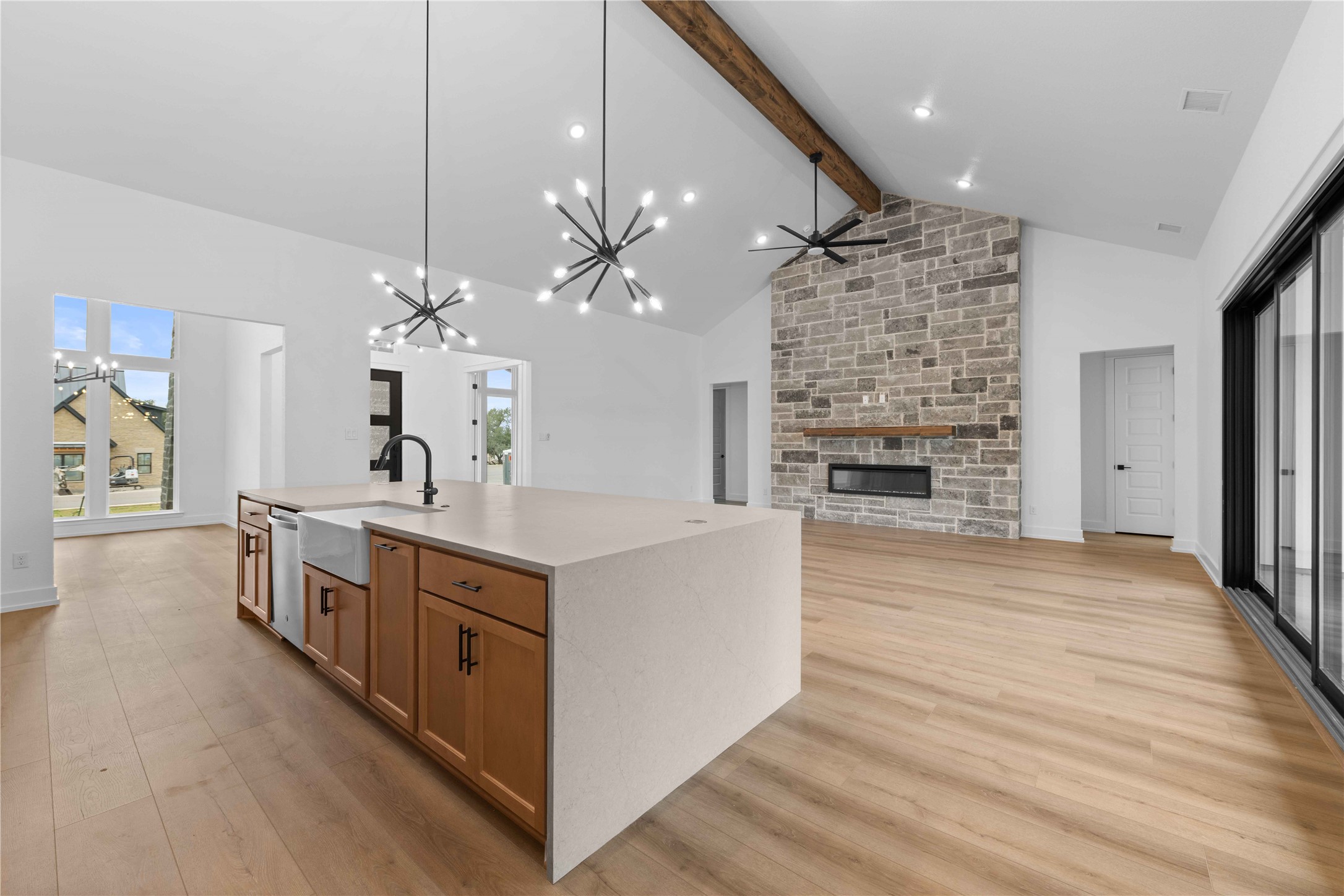 520 Vale Pond Spur Georgetown, TX 78633 - Photo 28 of 32 a large kitchen with kitchen island a stove a sink a center island and wooden floor